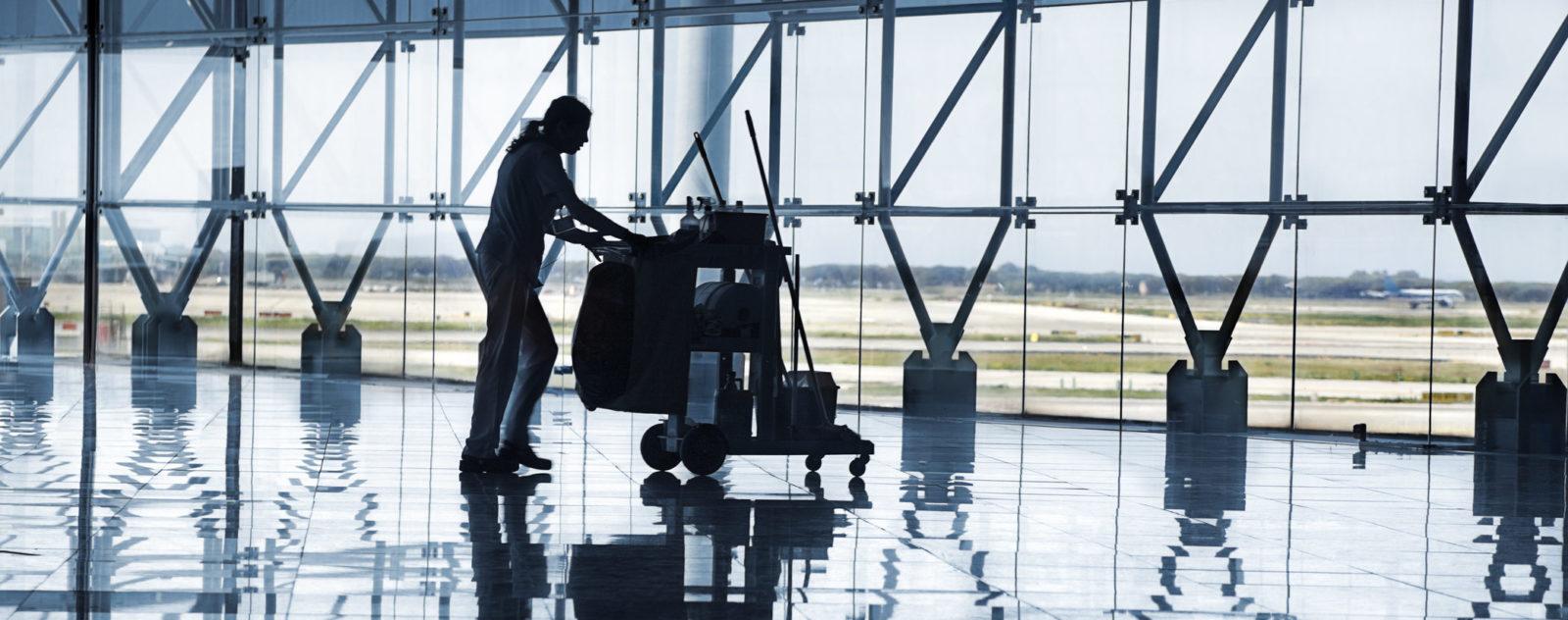 Cleaning person in airport terminal